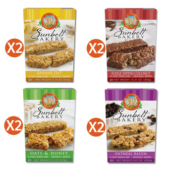Image of the Sunbelt Bakery Tasty Flavors Sampler, featuring four different flavors of chewy granola bars. The sampler includes two cartons each of Banana Oat, Fudge Dipped Coconut, Oats & Honey, and Oatmeal Raisin granola bars. Each box is displayed with an "X2" icon indicating the quantity included in the sampler. The boxes show the Sunbelt Bakery logo and an image of the corresponding granola bars on the front.