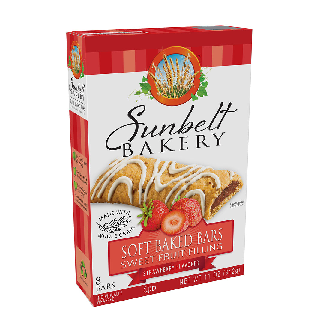 The box of Sunbelt Bakery Strawberry Flavored Soft Baked Bars, featuring an appetizing image of a whole grain bar with white glaze and strawberry flavored filling, with slices of strawberries in the foreground. The box is detailed with 'Made with Whole Grain' and states '8 Individually Wrapped Bars', with a net weight of 11 oz (312g). A red and white gingham pattern adorns the top of the box, with the Sunbelt Bakery logo and an illustration of wheat stalks above the product name.